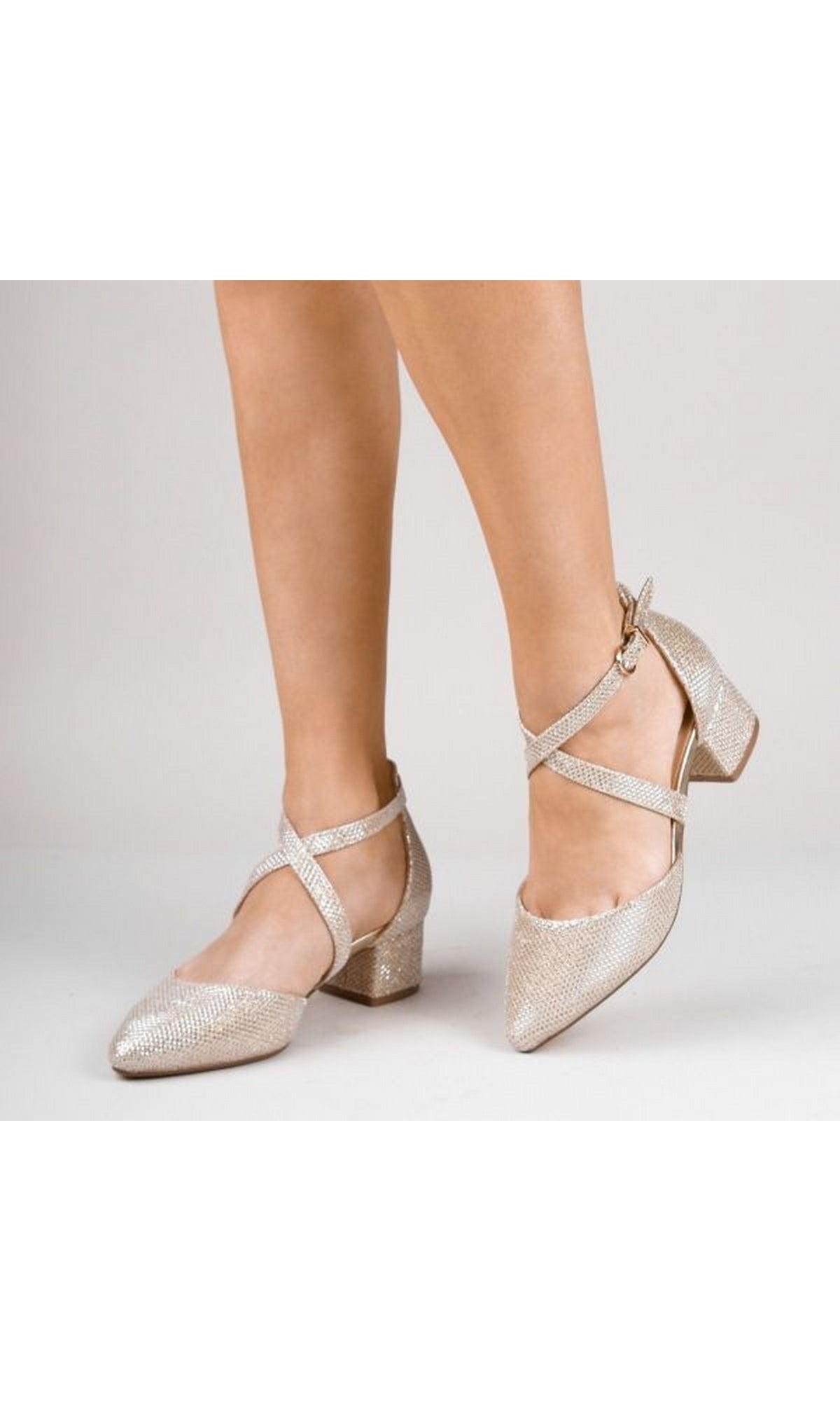 A person wearing Francis Champagne Closed Toe Low Heel Prom Shoes P2227 by Paradox London stands on a plain white background.